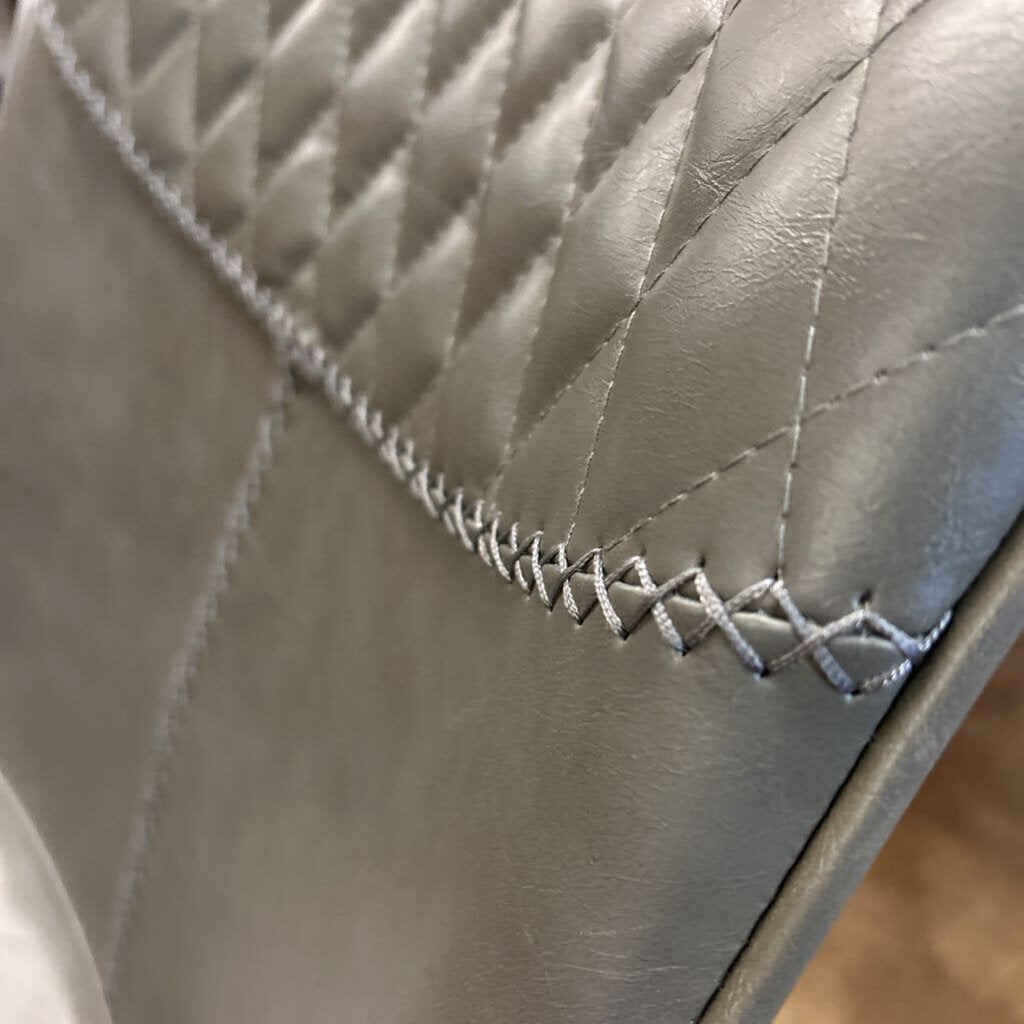 Close-up of quilted leather with stitching detail