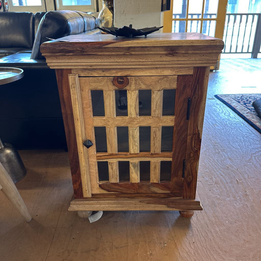 Wooden side table with glass panels in a living room setting