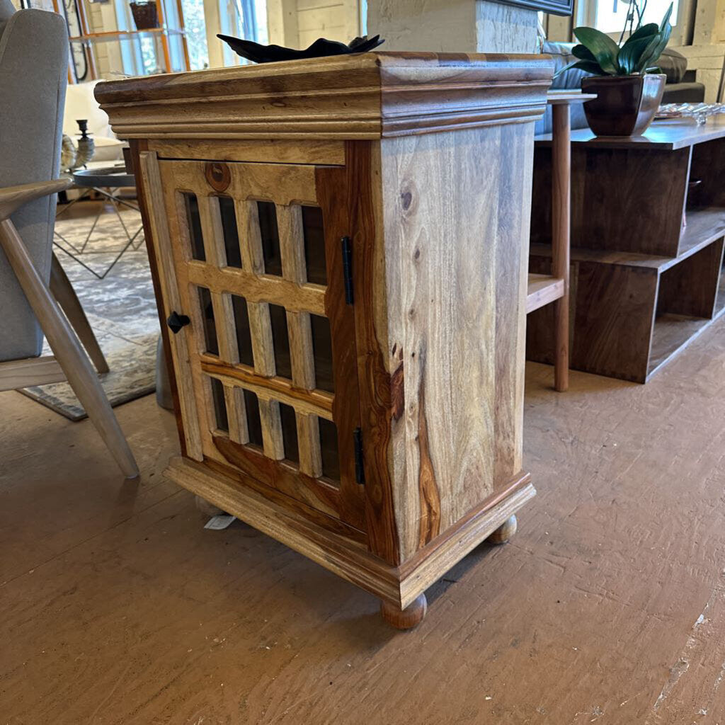Wooden side table on a wooden floor with a blurred background