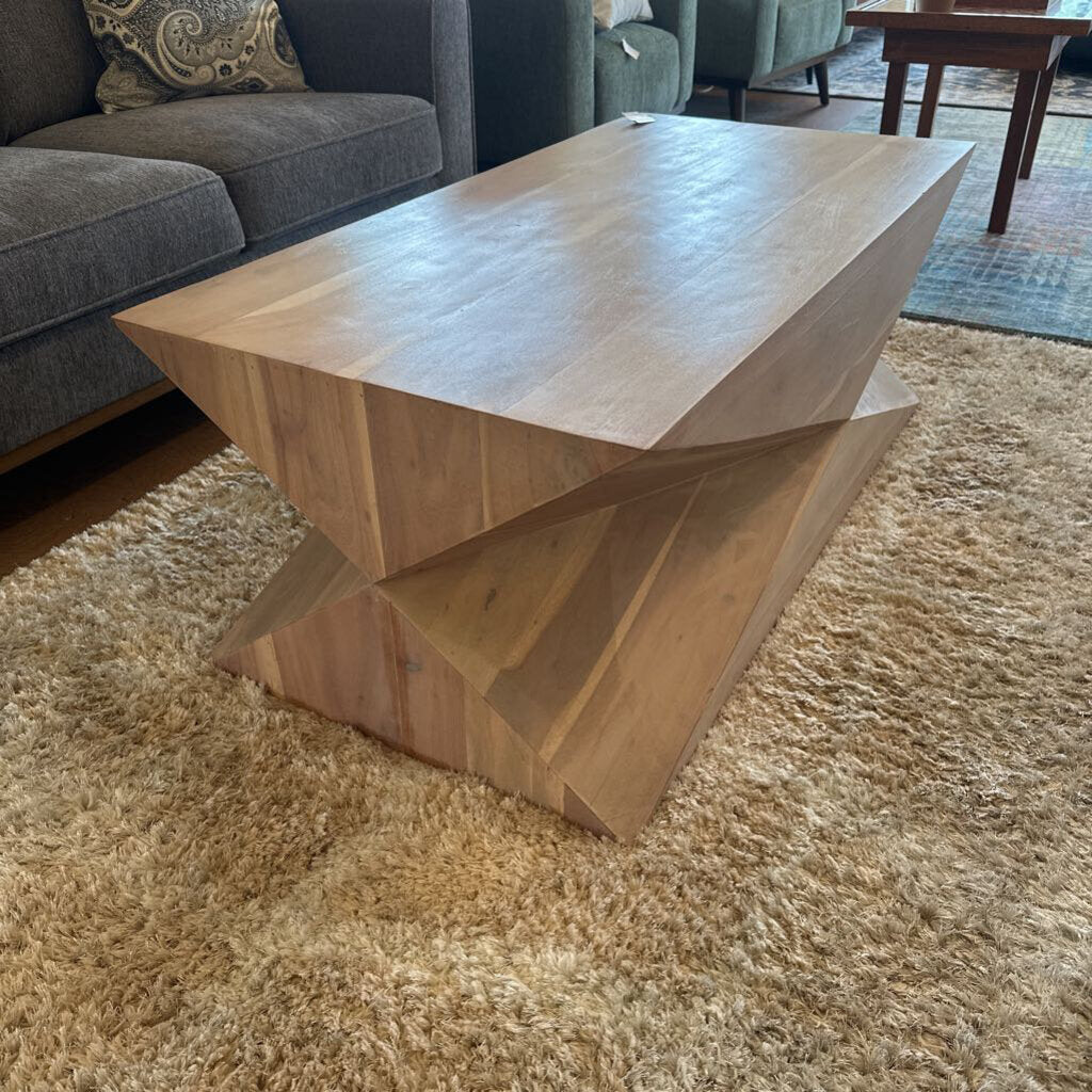 Wooden coffee table with geometric design in a living room setting