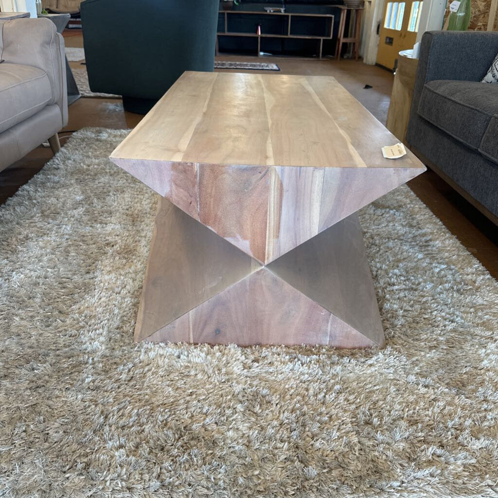 Wooden coffee table with geometric design in a living room setting