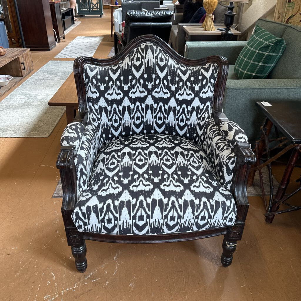 Chair with black and white patterned fabric in a furniture store setting