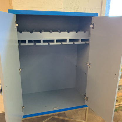 Metal cabinet with open doors showing interior shelves on a light-colored floor.