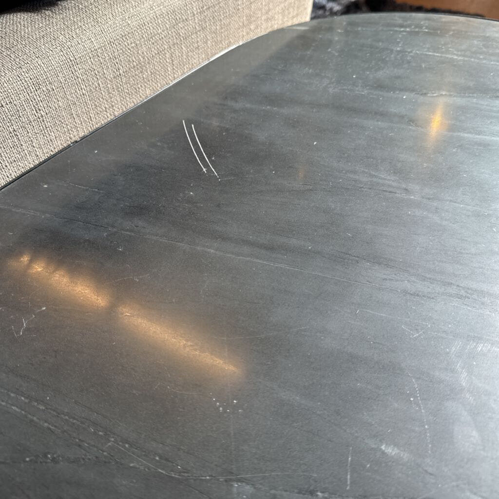 Close-up of a metallic surface with visible scratches and reflections