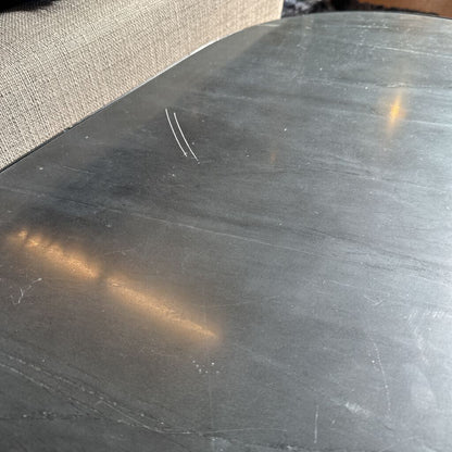 Close-up of a metallic surface with visible scratches and reflections