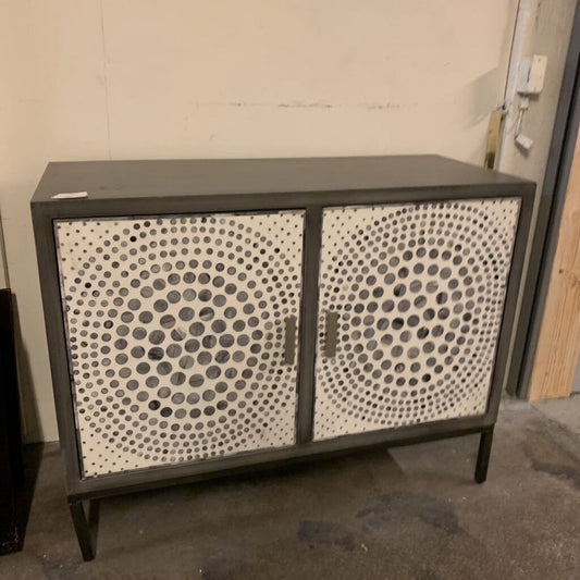 Cabinet with circular patterned doors in a room setting