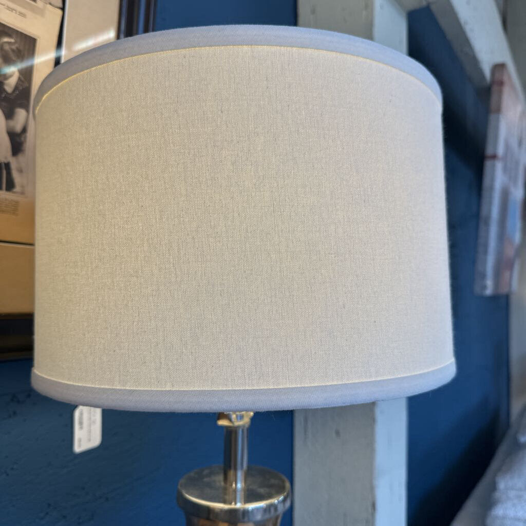 Beige lampshade on a stand with a blurred background