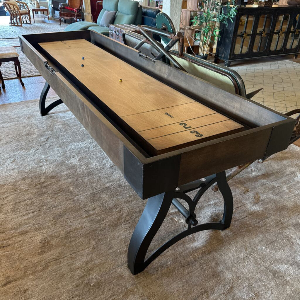 Shuffleboard table in a room with furniture and decor