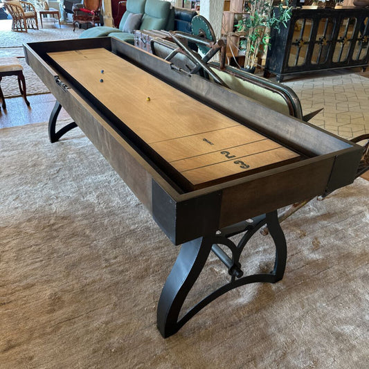 Shuffleboard table in a room with furniture and decor