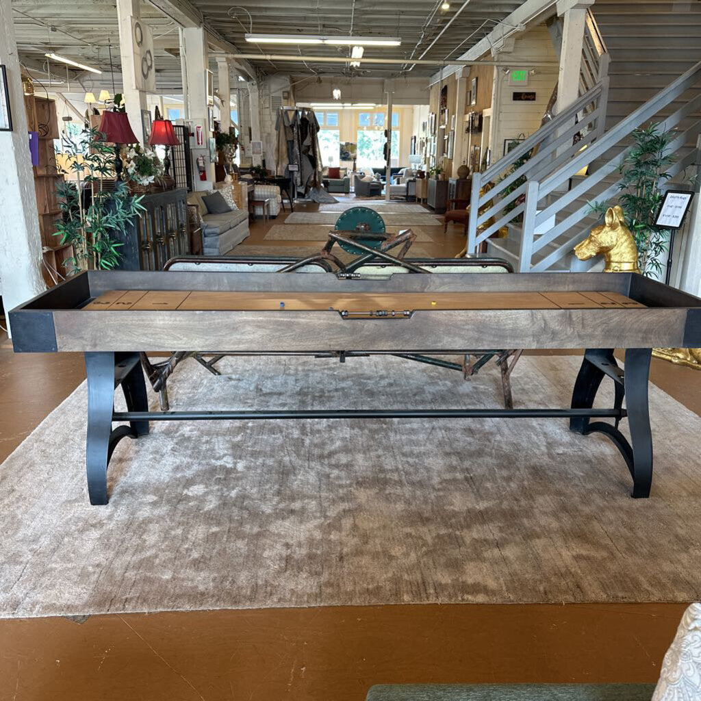 Wooden pool table in a room with furniture and decor