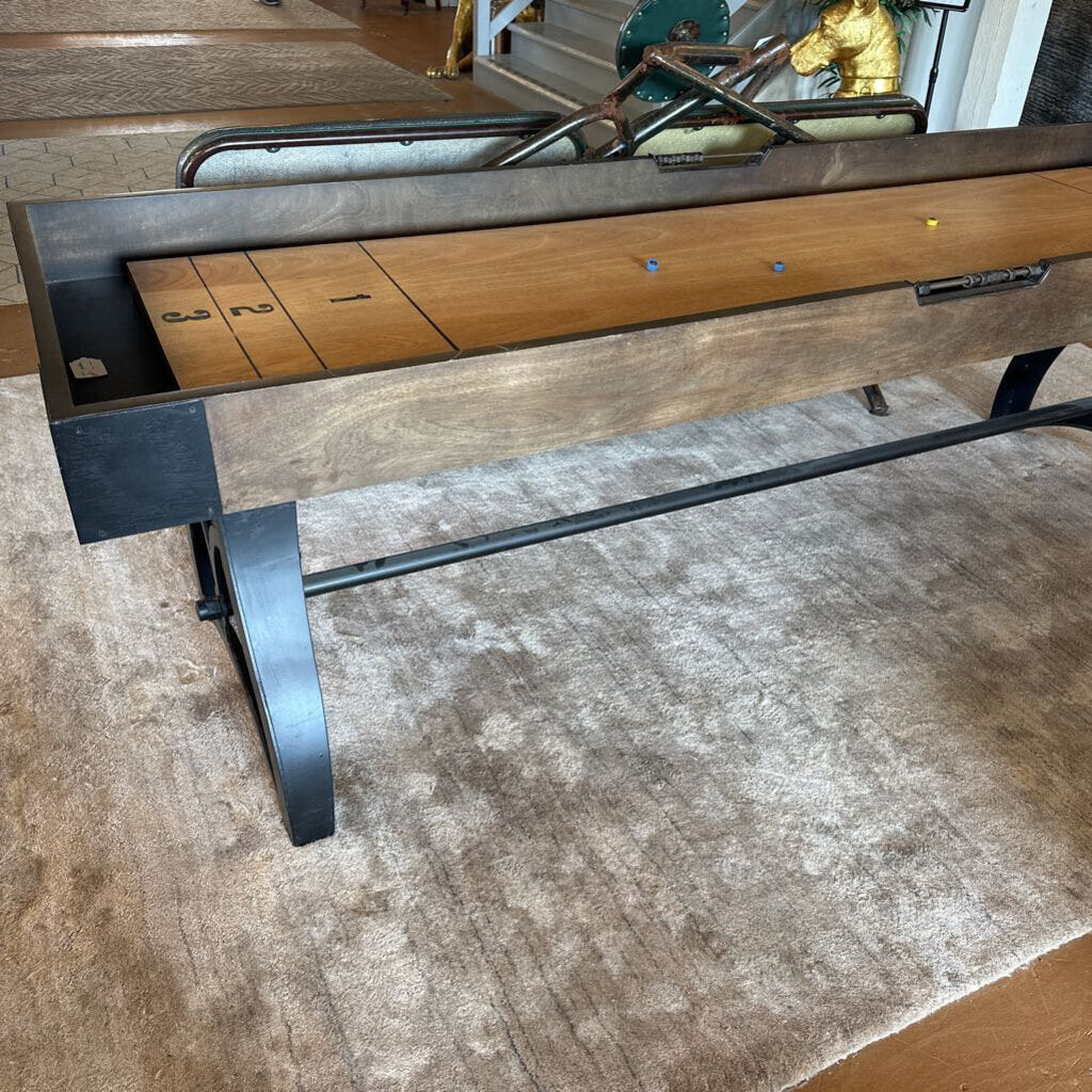 Wooden table with metal legs on a textured floor