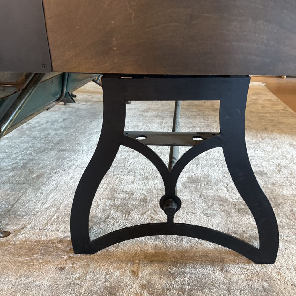 Black metal base of a piece of furniture on a concrete floor