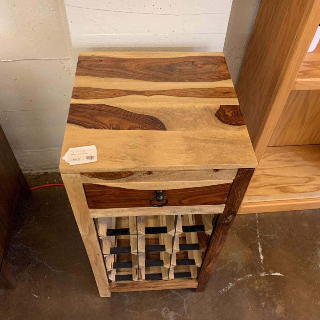 Wooden wine rack with a label on a concrete floor