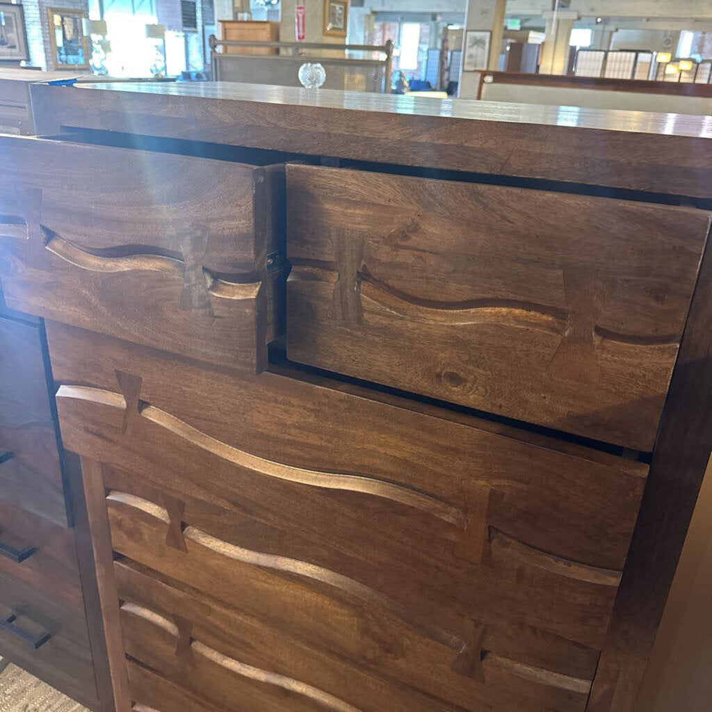 Wooden dresser with three drawers in a room setting