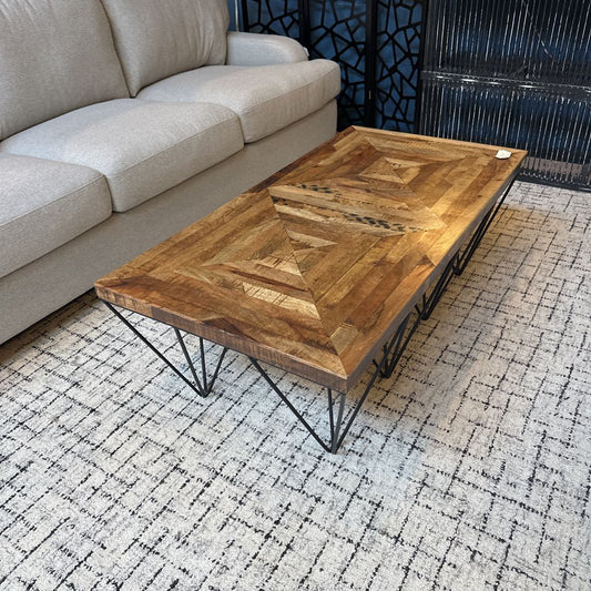 Wooden coffee table with geometric design in a living room setting