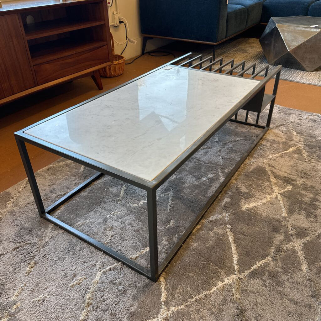 Coffee table with marble-like top and metal frame in a living room setting
