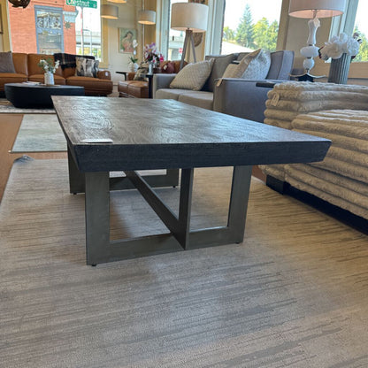 Wooden coffee table in a living room setting with furniture and decor.