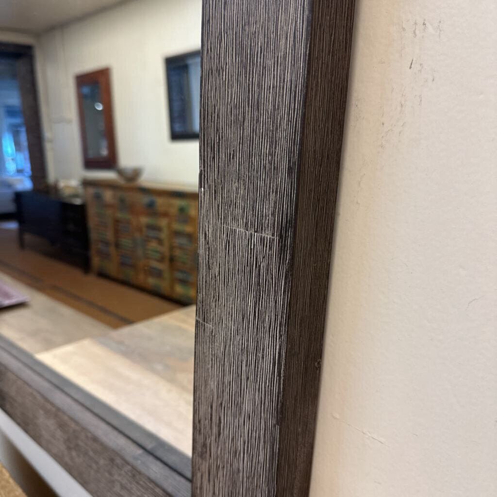Close-up of a wooden frame with a blurred interior background
