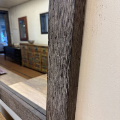 Close-up of a wooden frame with a blurred interior background
