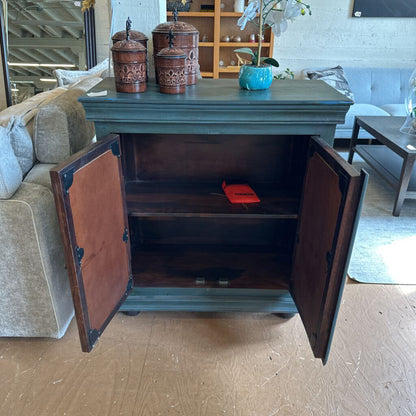 Wooden cabinet with open doors in a living room setting