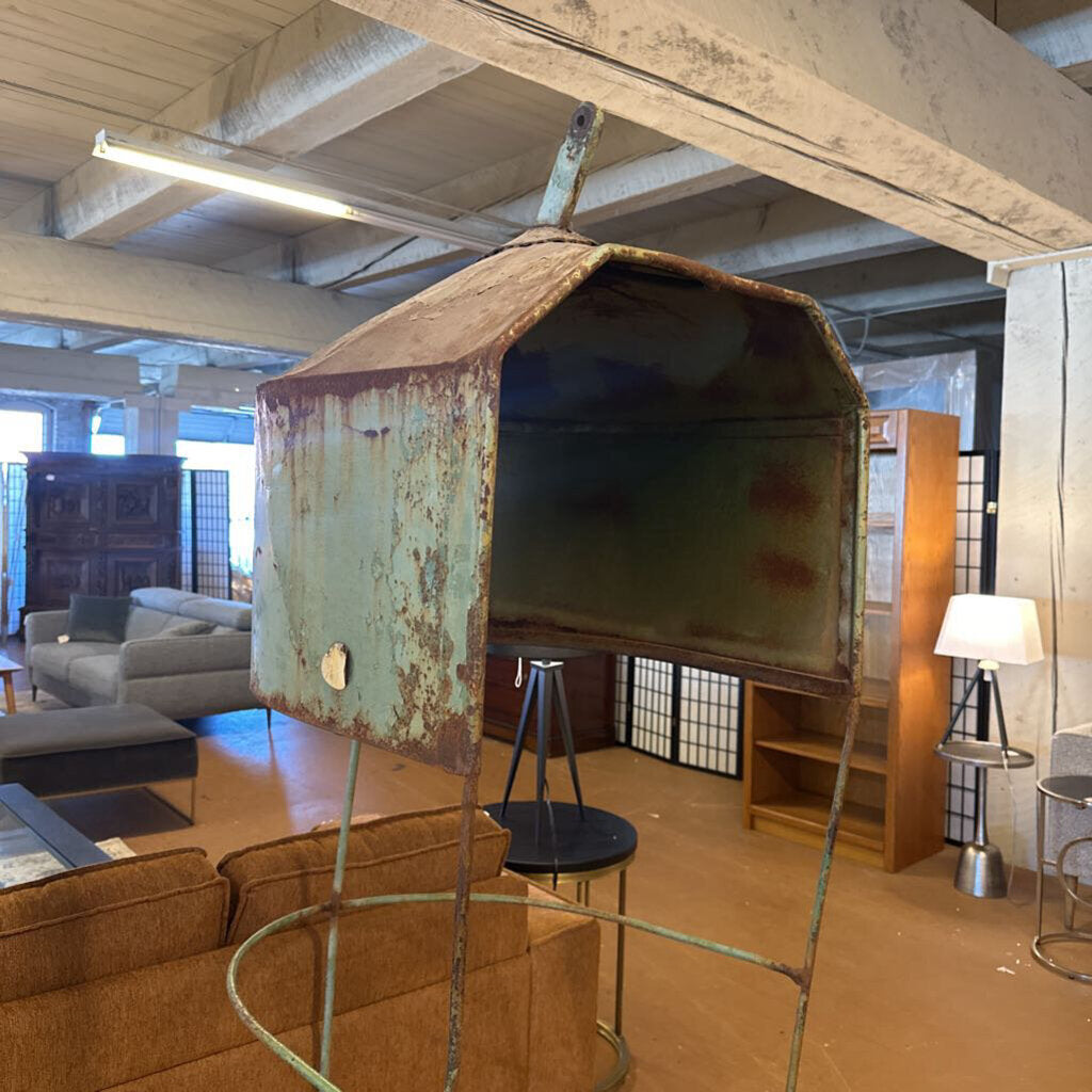 Rust-covered metal object in a room with furniture and decor