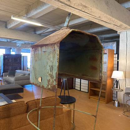 Rust-covered metal object in a room with furniture and decor