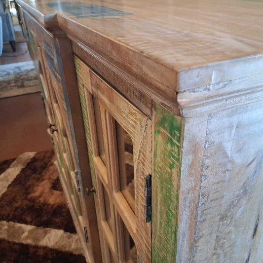 Wooden cabinet with a textured surface and green accents