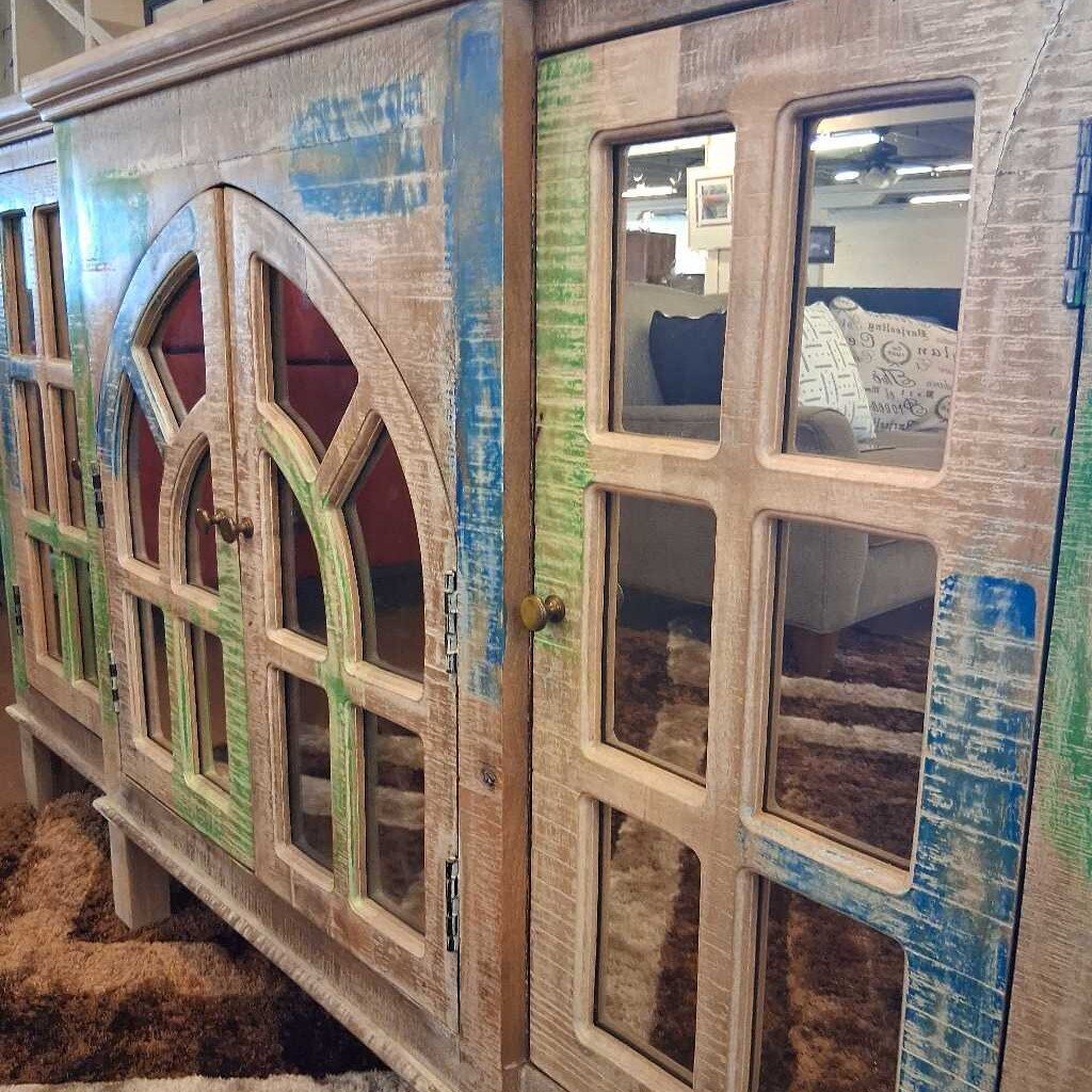 Wooden cabinet with decorative glass panels in a store setting