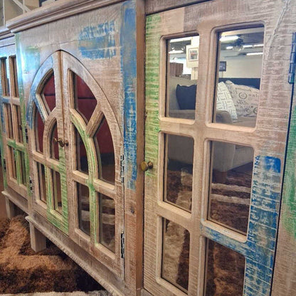 Wooden cabinet with decorative glass panels in a store setting