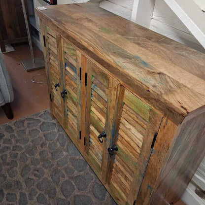 Wooden cabinet with shutter doors in a room setting