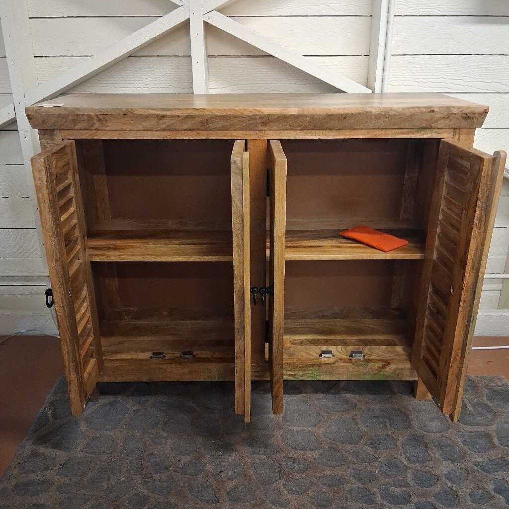 Wooden cabinet with open doors on a stone floor