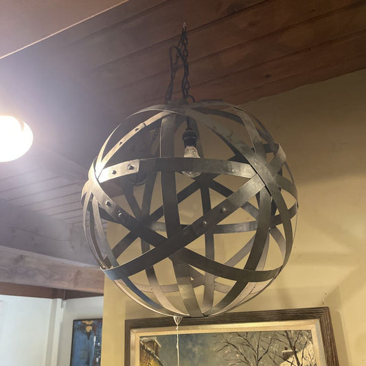 Decorative spherical metal light fixture hanging from a ceiling.