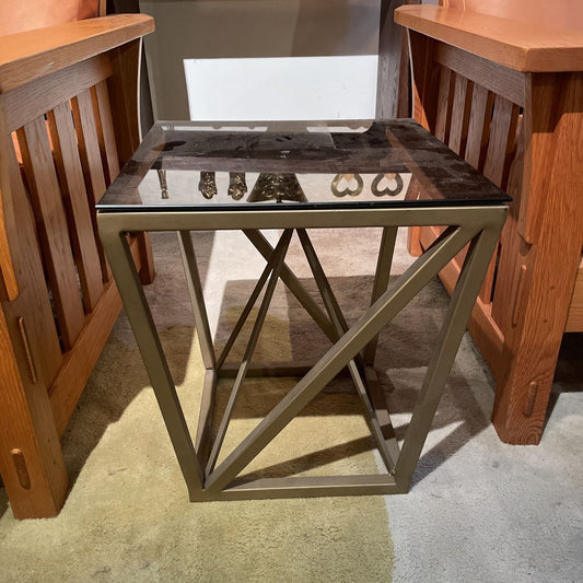 Small side table with marble top and metal base in a room setting