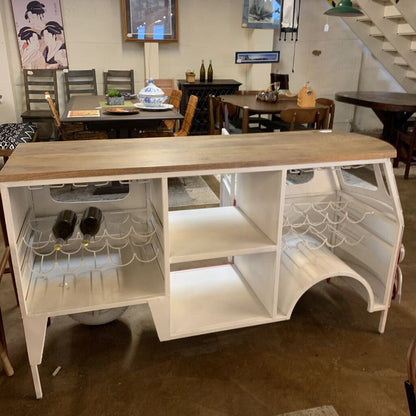 White kitchen island with wooden top in a room setting