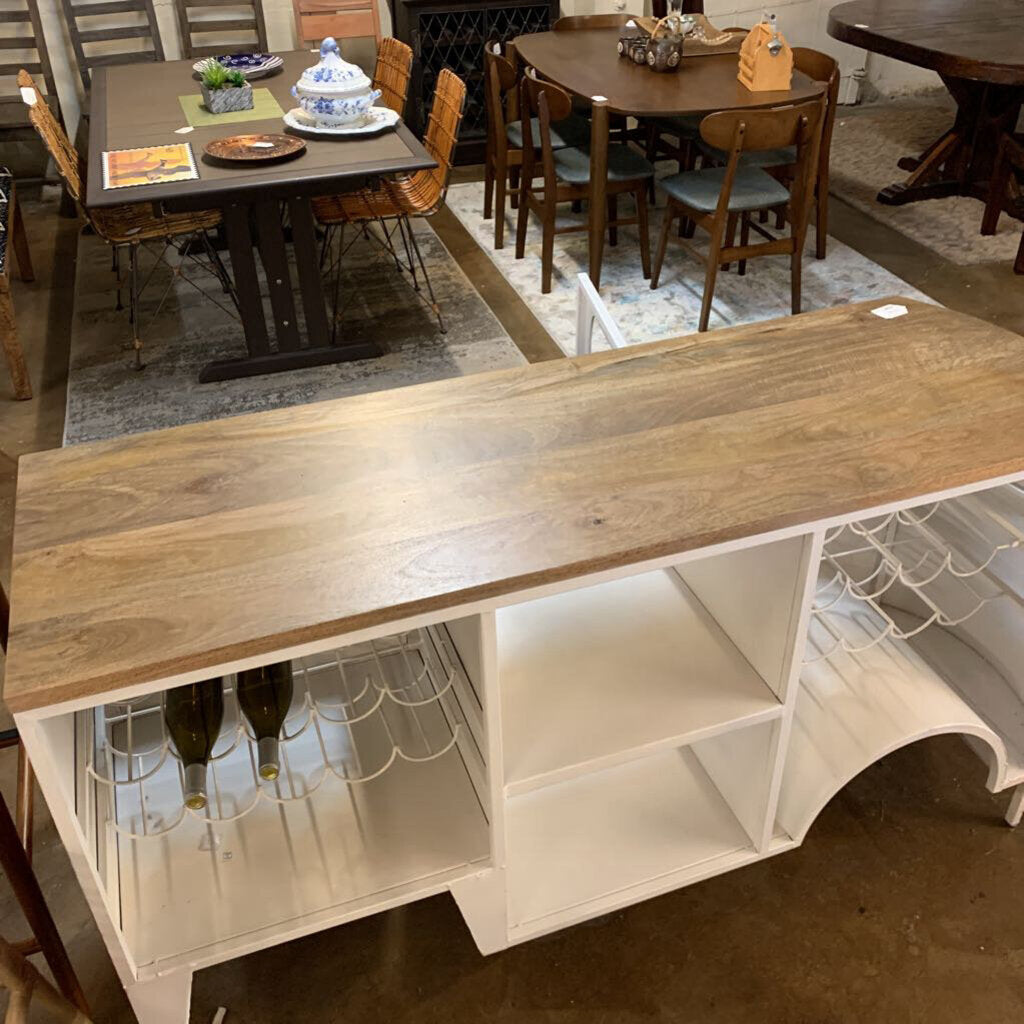 Wooden table with wine bottle holders in a showroom setting