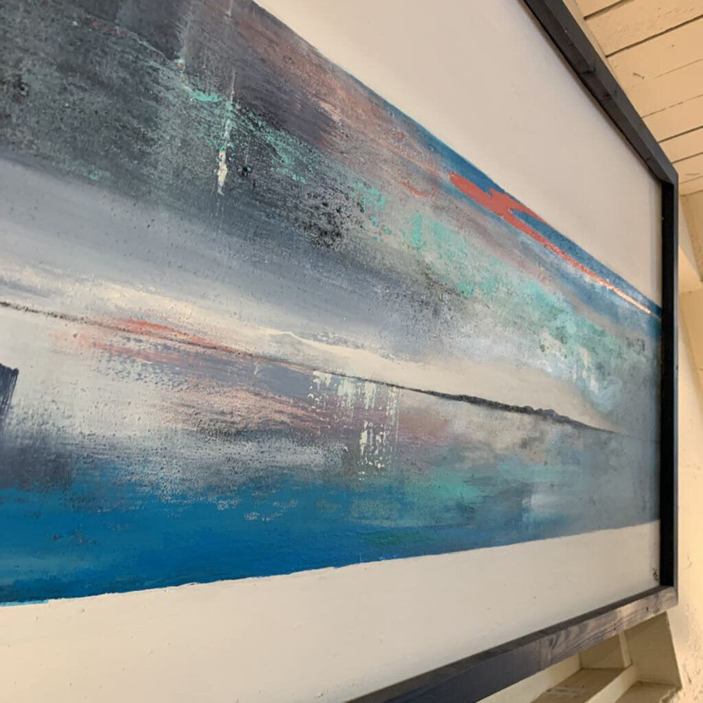 Abstract painting with blue, white, and red colors on a wall.