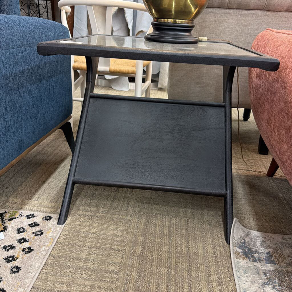 Black side table in a room with furniture and decor