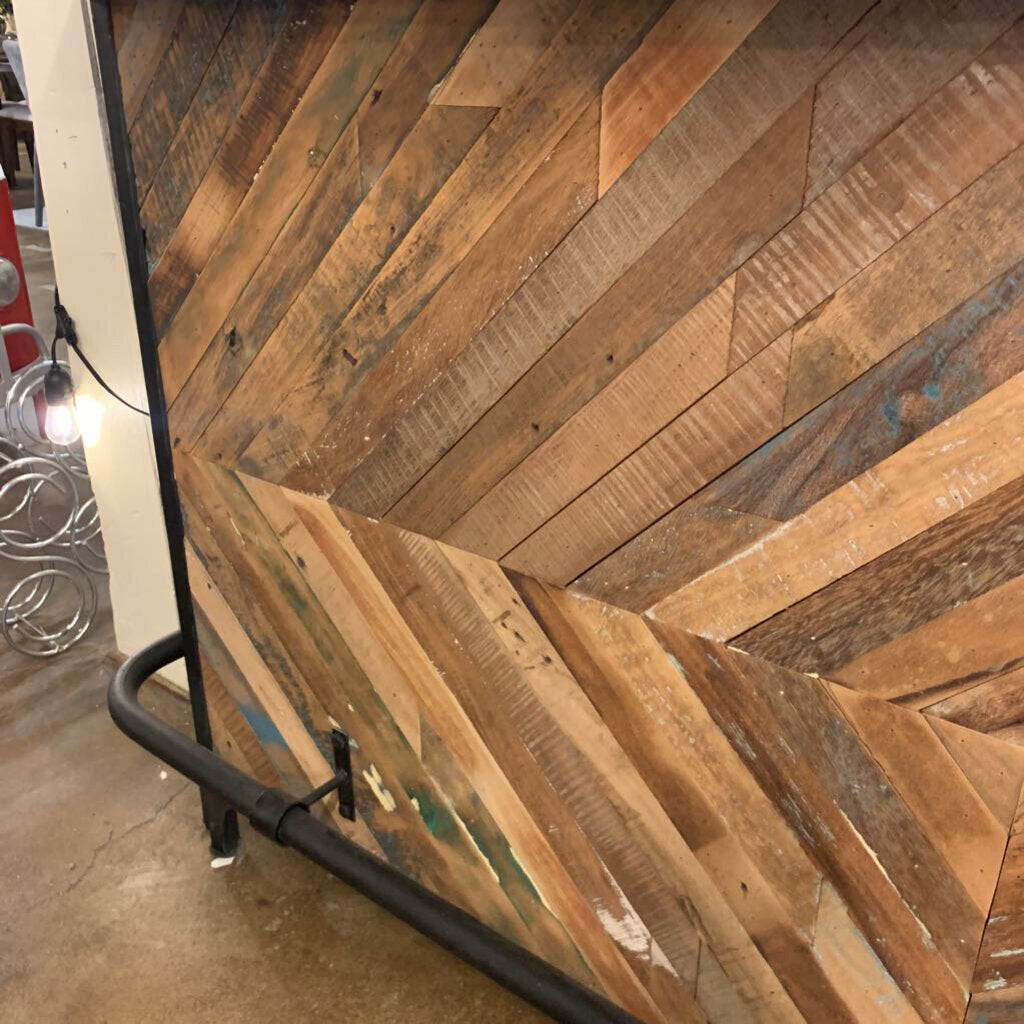 Wooden wall panel with a chevron pattern in a room setting