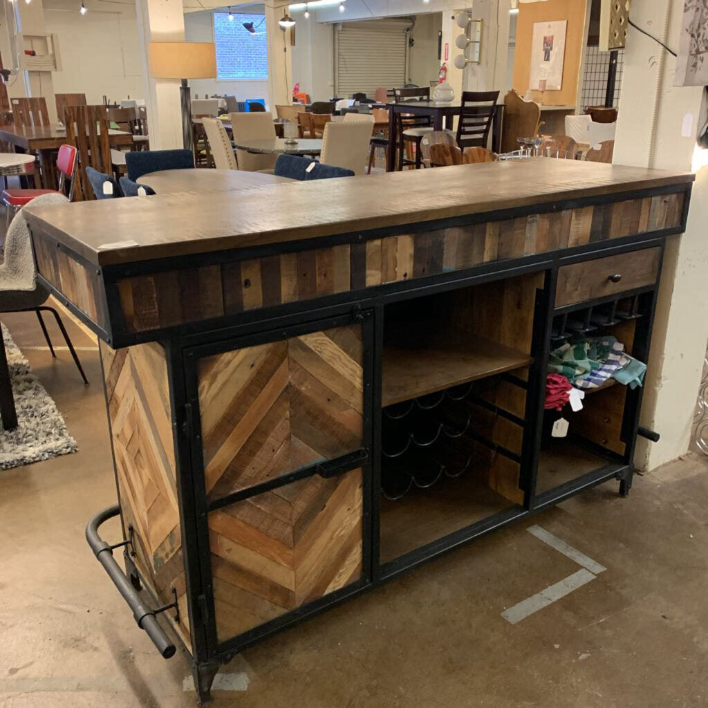 Wooden bar counter with storage shelves in a showroom setting