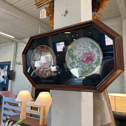 Decorative mirror with floral plates in a rustic setting
