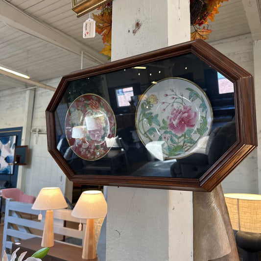 Decorative mirror with floral plates in a rustic setting