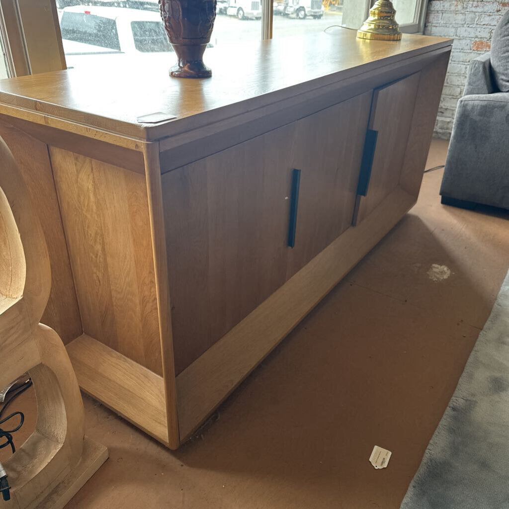 Wooden cabinet with a glass panel in a room setting