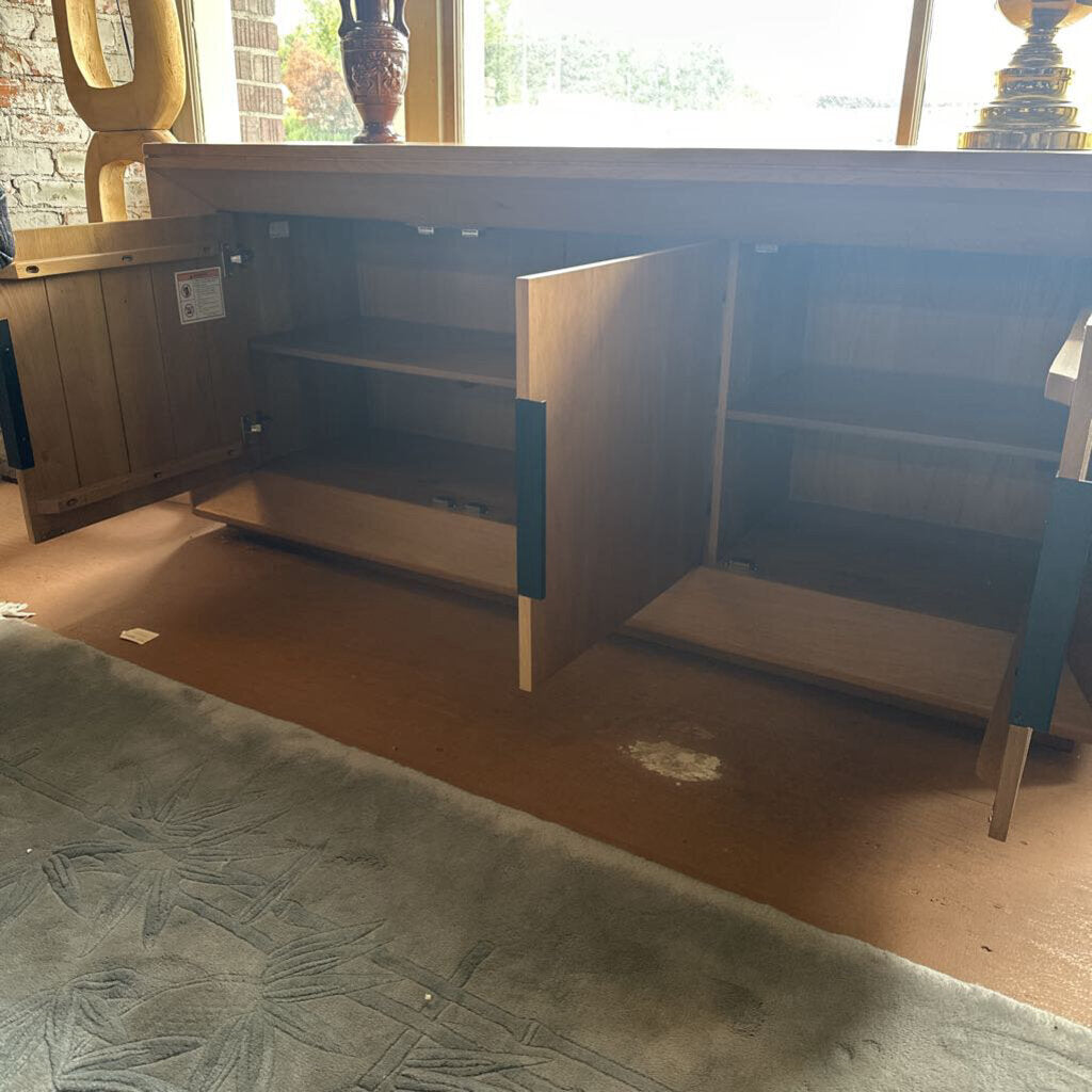 Wooden cabinet with open door on a carpeted floor