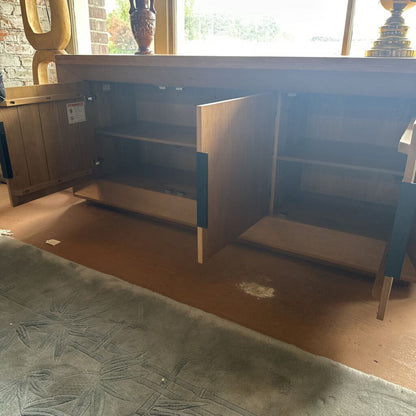 Wooden cabinet with open door on a carpeted floor