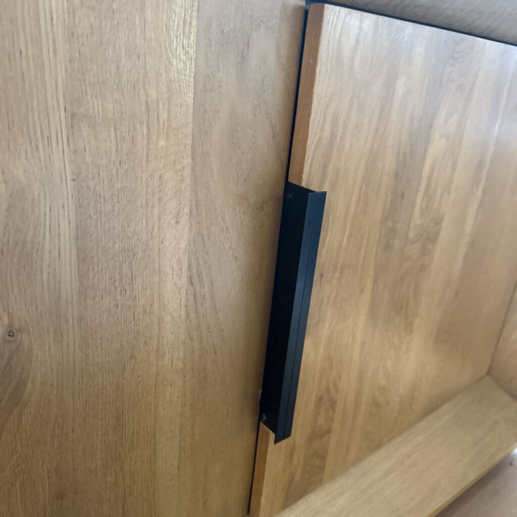 Wooden cabinet with a black handle