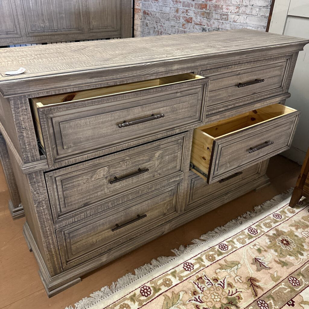 Wooden dresser with multiple drawers in a room setting