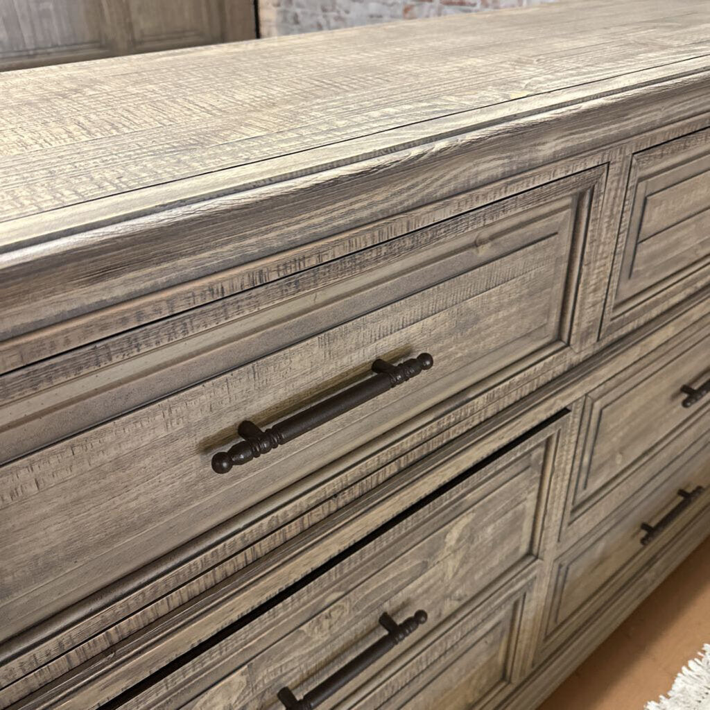 Wooden dresser with decorative handles on a blurred background