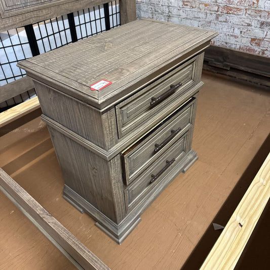 Wooden nightstand with two drawers on a wooden floor.