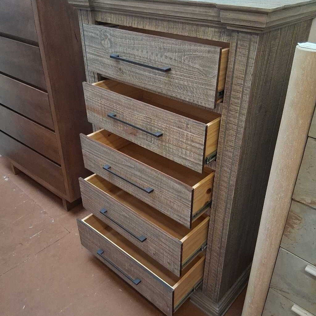 Wooden dresser with open drawers in a room setting