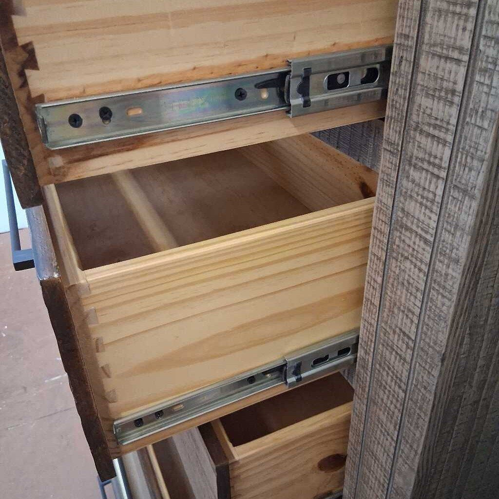 Wooden drawer with metal slides being pulled out